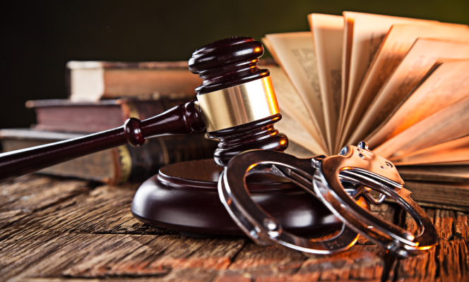 Wooden gavel and books on wooden table, law concept